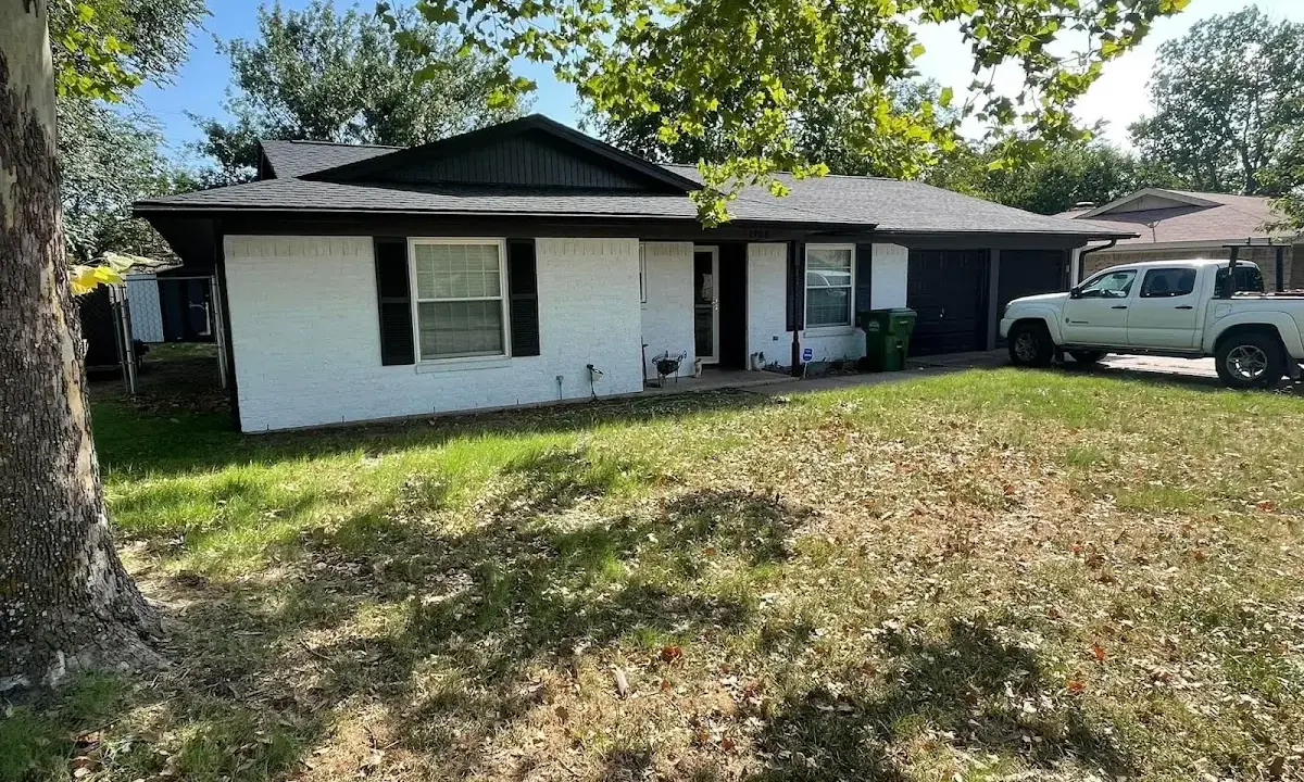 Professional roofing crew working on a residential roof in Stoneham